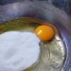 Trong một thau nhỏ, đánh tan 2 trứng gà với 120g đường. Sau đó cho 1 muỗng cà phê vani vào, đánh tan. Sau đó, cho hỗn hợp bột vào, trộn đều thành một khối.