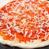 Dùng thìa phết đều một lớp sốt vừa trộn lên đế bánh pizza. Rắc một lớp phô mai bào nhỏ lên trên sốt.