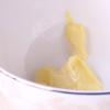 Ở một bát khác, cho bơ lạt vào, dùng phới miết nhuyễn bơ. Sau đó, từ từ thêm sữa tươi không đường, vani và whipping cream vào và trộn đều.