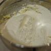 Rây qua 150gr bột mì vào hỗn hợp bơ, đường. Tiếp theo, cho bột hạt dẻ, hạt hồ đào nghiền nhỏ vào, trộn đều.