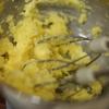 Khi bơ chuyển màu vàng nhạt, đổ từ từ 15ml sữa tươi vào, tiếp tục đánh đều.