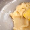Chia bột mì thành 2 phần, lần lượt đổ từng phần vào nồi bơ. Sau lần đổ thứ nhất bạn khuấy cho bột tan đều rồi mới tiếp tục đổ phần bột còn lại và khuấy cho bột tan hoàn toàn. Tiếp tục khuấy đến khi bột không dính đáy nồi thì tắt bếp, để bột nguội bớt trong khoảng 5-10 phút.