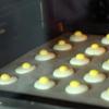 Cho 2 lòng đỏ trứng gà vào thố, thêm 7g sữa bột vào đánh cho bông nhạt. Cho hỗn hợp lòng đỏ trứng vào túi bóp kem rồi bóp lên các chiếc bánh lòng trắng. Đặt tiếp vào lò nướng tiếp 40 phút.