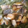 Cho cá rô phi đã chiên vào, nêm nếm gia vị hạt nêm, muối cho vừa ăn.