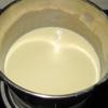 Đun nóng già sữa tươi không đường và kem sữa tươi với 3 muỗng canh đường trên lửa nhỏ, khuấy cho đường tan.