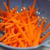 Cà rốt thái sợi rồi mang đi rửa. Để giá, hẹ, cà rốt sau khi rửa lên rổ cho ráo nước. 