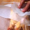 Cho thịt gà vào giấy nến, gấp các mép của giấy nến lại cố định.