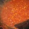 Thêm cà chua xay vào, hạ nhỏ lửa đun sôi khoảng 15 phút cho cà chua và cà rốt chín. Cho bơ và sốt cà chua vào, khuấy đều. Tắt bếp, nêm 1/2 đường, 1/2 muối, 1/2 nước mắm, bột ngọt vào, trộn đều.