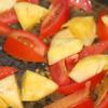 Làm nóng dầu ăn trong chảo, cho thơm, cà chua vào xào qua khoảng 5 phút.